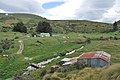 English: Looking across Deepdell Creek to the Callery House at the Golden Point Mine Historic Area near Macraes Flat, New Zealand