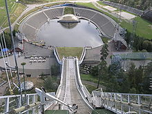 View from the old tower in summer; in the off-run is Besserudtjernet, with the stage visible opposite the in-run Holmenkollbakken2.JPG