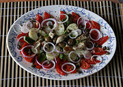 Insalata pantesca con pomodoro, basilico, olive, cipolla, capperi, origano, olio d'oliva