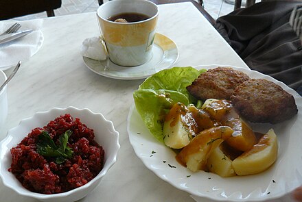 A typical Polish meal: kotlety mielone (minced pork cutlet), potatoes, beets and tea with lemon