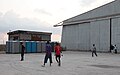 refugee camp at Hal Far: airplane hangar, toilets outside