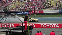 The NASCAR Cup Series at Watkins Glen International Raceway in Watkins Glen, New York Marcos Ambrose Celebrating winning the 2012 Finger Lakes 355 at the Glen.jpg