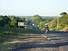 Biker riding south along a highway on his way to Granada, Nicaragua