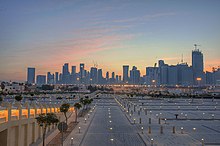 Parking lot for Imam Muhammad ibn Abd al-Wahhab Mosque with West Bay skyline in background. Parking lot for Mohammed bin Abdulwahab Mosque in Qatar.jpg