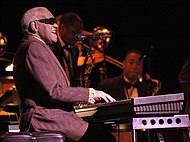 Ray Charles won five Grammys in 2005, less than a year after his death. Ray Charles FIJM 2003.jpg