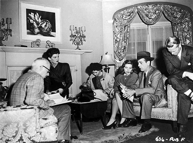 Cast of The Big Sleep between scenes, director Howard Hawks far left