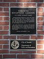 Sign on the brick wall beside the northerly entrance gate to the Toronto Sculpture Garden, on King Street East