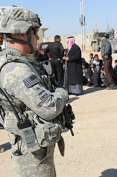 File:U.S. Army Sgt. John Dimick, left, with Delta Company, 3rd Battalion, 15th Infantry Regiment, 4th Advise and Assist Brigade, 3rd Infantry Division, stands guard as Iraqi Police Service officers conduct a 110302-A-TO648-005.jpg