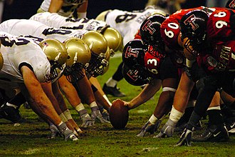The defensive and offensive lines square off prior to a snap US Navy 031230-N-6213R-507 The Navy defensive line and Texas Tech offensive line square off prior to a snap in the EV1.Net Houston Bowl at Reliant Stadium in Houston, Texas.jpg
