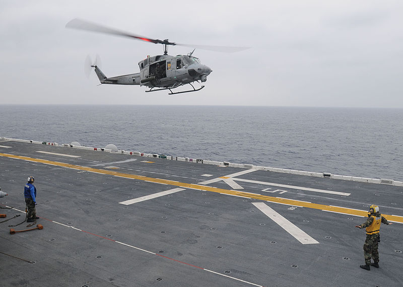 File:US Navy 100122-N-9950J-027 Aviation Boatswain's Mate (Handling) 3rd Class Patrick Neimeyer, from Montgomery, Ala., directs the landing of a UH-1N Huey helicopter aboard the forward-deployed amphibious assault ship USS Essex (LH.jpg