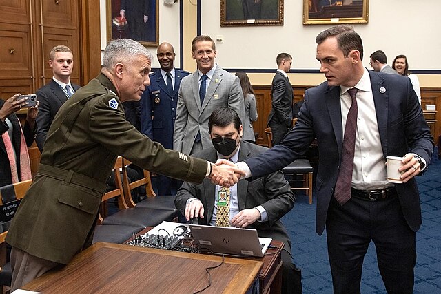 As chairman of the House Armed Services Committee subcomittee for cyber programs, Representative Mike Gallagher greets Army Gen Paul Nakasone, March 2