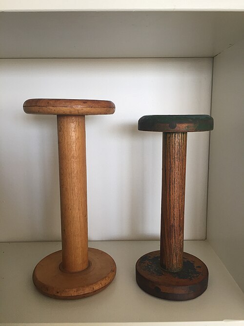 Vintage wooden bobbins, cylindrical, empty of wound fiber, dimensions 16 in. high by 9 in. in diameter.