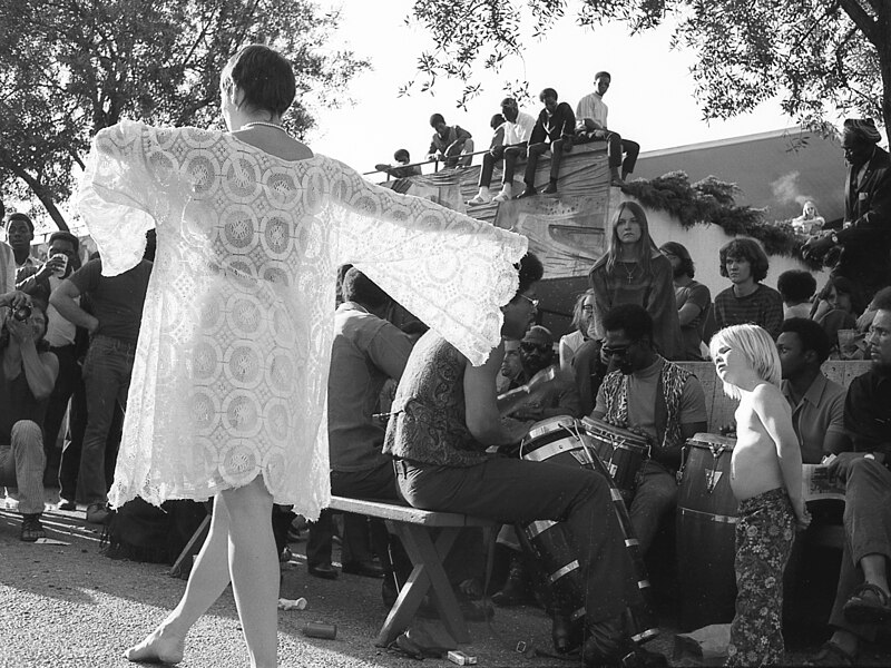 File:Woman in white dancing amidst a crowd of people, Berkeley, April 1971.jpg