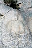 Seated stone Buddha statue Carved on the Rock at Yongjangsa temple site, Namsan Mountain in Gyeongju, Korea