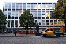 The new building at Boschstraat. In the foreground the statue of Petrus Regout [nl], the 19th-century founder of the Maastricht potteries 2015-10-05 Maastricht, UNU Merit & Regout.jpg