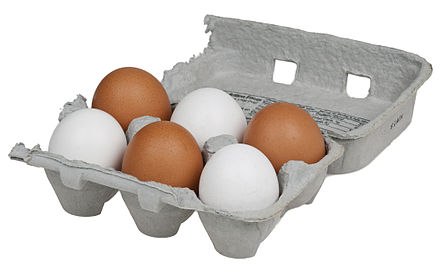 White and brown eggs in an egg crate