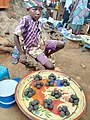 A boy is selling dawadawa(kɔlekɔ