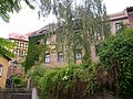 Residential house (former archdeaconate) in semi-open development, consisting of two house parts, as well as retaining wall of the property