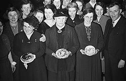 Women with crempogau at a traditional Shrove Tuesday Dance in Trewern (1940). Annual Pancake Day Dance at Trewern (8470993092).jpg