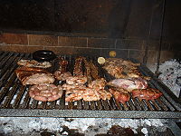 A typical Argentine asado assortment consisting of chicken, beef, pork, ribs, pork ribs, chitterlings, sweetbread, sausages and blood sausages