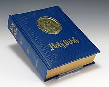 A King James Bible bound in blue faux-leather cloth.