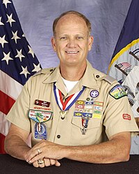 Retired US Navy captain Bill McKown wearing his Boy Scouts of America leader's uniform with twelve square knots instead of the maximum nine allowed BillMcKownDESA.jpg