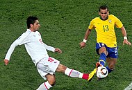 Alves competing for the ball against Chile's Gonzalo Jara at the 2010 FIFA World Cup.