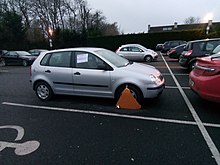 Clamped car (Volkswagen Polo Mk4) in Ireland, with note on driver's side window warning the owner not to attempt to drive away. Clamped car, Ireland.jpg