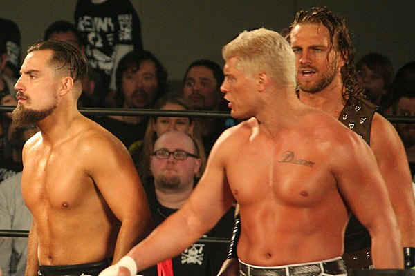 Page (right) with fellow Bullet Club members Marty Scurll (far left) and Cody Rhodes in 2018