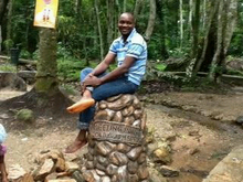 A man sitting at the confluence of the springs Confluence of ikogosi Warm Springs.png