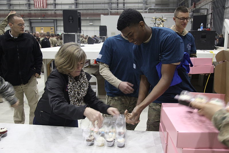 File:Deanie Dempsey, second from left, the wife of Chairman of the Joint Chiefs of Staff U.S. Army Gen. Martin E. Dempsey, helps USO volunteers open the Georgetown Cupcakes that were shipped on a pallet to be handed 131209-A-WS742-137.jpg