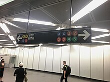 Signs in the Fulton Center (like this one) only show the E, R and W train symbols when pointing toward the Chambers Street/World Trade Center station, as the A, C, 2 and 3 trains serve both station complexes. Dey street passageway sign.jpg