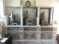 Monument to the Drake family of Ash, south aisle of Musbury Church. It depicts the following persons: left: John Drake (died 1558), with his wife Amy Grenville (died 1577); centre: Admiral Sir Bernard Drake (c. 1537 - 1586), his son, with his wife Gertrude Fortescue (died 1601); right: John Drake (died 1628), who erected the monument in 1611, son of Sir Bernard, with his wife Dorothy Button (died 1631). Also shown four times are the arms of Drake: Argent, a wyvern wings displayed and tail nowed gules. Gilded inscribed biographical tablets appear under each couple of kneeling figures DrakeMonument MusburyChurch Devon.PNG