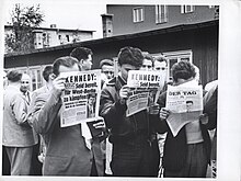 East German refugees reading news accounts of President John F. Kennedy's July 25, 1961, address to the American people about the growing conflict with the Soviet Union over the status of Berlin. East German Refugees - Flickr - The Central Intelligence Agency (1).jpg