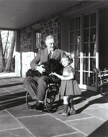 One of Suckley's photographs of Roosevelt with Ruthie Bie (later Bautista), then three years old, the daughter of the property caretakers and Fala (1941)