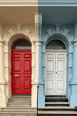 Close-up of the red and white doors of the coloured houses of Grand Parade, West Hoe, Plymouth.