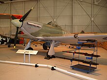 A Hawker Hurricane II on display in the War in the Air hangar. A selection of armament used by the type is also displayed. HawkerHurricaneCosford.JPG