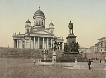 A colour photograph taken between 1890 and 1905. Helsinki Cathedral and statue of Alexander II (1890-1900).jpg