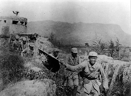 A Communist soldier waving the Nationalists' flag of the Republic of China after a victorious battle against the Japanese during the Second Sino-Japanese War