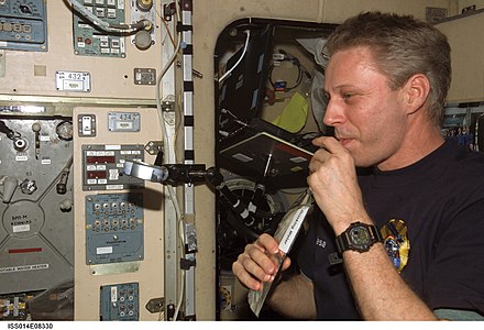 Astronaut Thomas Reiter during Expedition 14 drinking water on the International Space Station