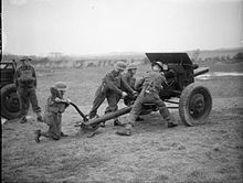 British airmen man a 75mm field gun during training at No. 2 RAF Regiment School, Whitley Bay (then Northumberland), UK.