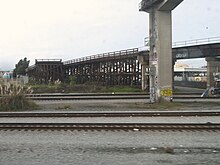 The former trestle over the SP mainline near 26th Street in Oakland, seen in December 2021. Interurban Electric Railway trestle in Oakland, December 2021.JPG