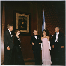 Kennedy in a pink sari-inspired dress made by Oleg Cassini, 1963 JFK, Jackie, Andre Malraux, Lyndon B. Johnson, unveiling Mona Lisa, January 8, 1963.png