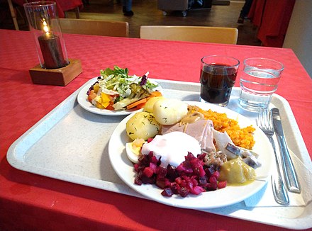 Christmas serving at a student cafeteria on Saint Lucy's Day: salad, kotikalja, casseroles, pickled herring, rosolli (root vegetable salad) with whipped cream, egg, potatoes with dill, and ham with mustard