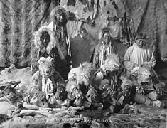 Kayiagamute (Kauwerak) Wolf Dancers wearing regalia against backdrop of furs, vicinity of Nome, Alaska, between 1908 and 1915 (AL+CA 6428).jpg
