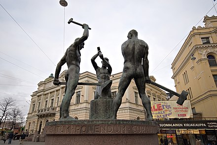 The Three Smiths Statue, situated at the intersection of Aleksanterinkatu and Mannerheimintie in Kluuvi, Helsinki, Finland