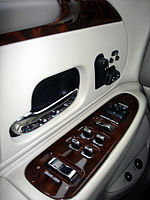 Inner door panel of a 1998 Lincoln Town Car, featuring a chromed door handle often associated with luxury cars.