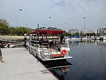 Flush decked dive boat with transom platform and ladder, and shade awning, suitable for tropical use over short distances. Marina da Gloria dive boat.jpg