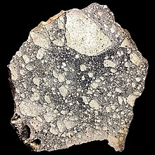 Large slice of NWA5000, the largest known lunar meteorite. It was found in the Sahara desert in 2007. NWA5000, large slice.jpg