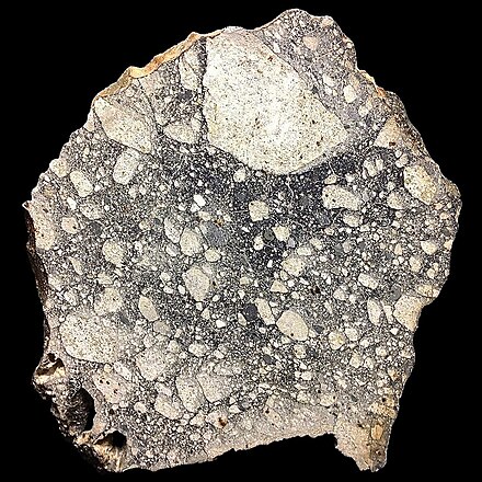 Large slice of NWA5000, the largest known lunar meteorite. It was found in the Sahara desert in 2007.[1]
